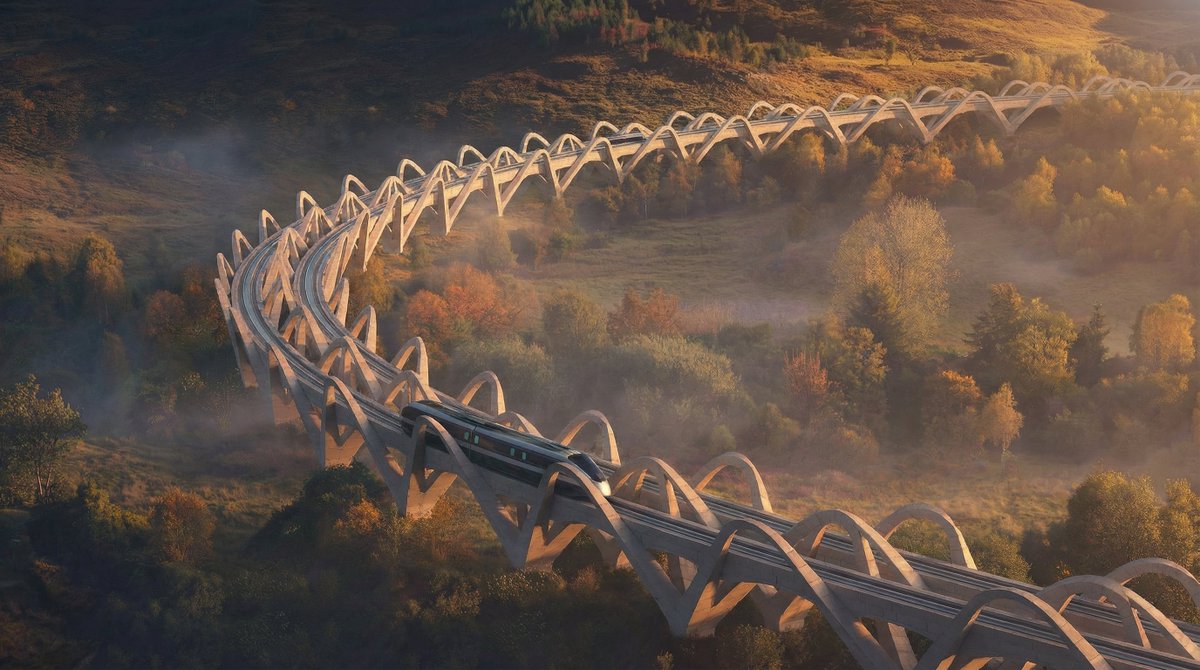 TheB1M's tweet photo. Proposals for a high-speed rail loop that would link nine urban centres across Great Britain and Ireland have been put forward by RIBA President Chris Williamson. The so-called ‘Northern Loop’ would create a ‘dispersed but connected’ global city of around ten million people.

Williamson suggests that the Northern Loop would cost £130BN to construct and deliver £12BN a year in economic benefits. He confirmed in a social media post on 8 February that the proposal had been submitted to the Royal Academy’s 2026 summer exhibition.

“Maybe I have been too influenced by the scale, the vision and the ambition of The LINE in Saudi Arabia, having worked on the high-speed stations running alongside the 170-kilometre city for the last few years,” said Williamson in a statement provided to The B1M. “But we in the British Isles should be equally ambitious about our future. At present the Government seems to expect each city to compete for the same investment funding, when we need to encourage connectivity and collaboration.”

Locally-sourced stone arches would be used to the elevate the tracks above the landscape – minimising disruption and creating the flat, straight runs that are key to any high-speed line. Engineering consultants Elliott Wood have provided input into the proposals from an early stage.

“Britain needs a vision that can excite the country, regenerate the economy and restore confidence,” said Williamson. “Architects once published manifestos. They were not always right, but they inspired, provoked and set out ideas they believed in. This project is intended as a return to that time.”

More here 👉 https://t.co/HVMggt4hm1

📷 Chris Williamson