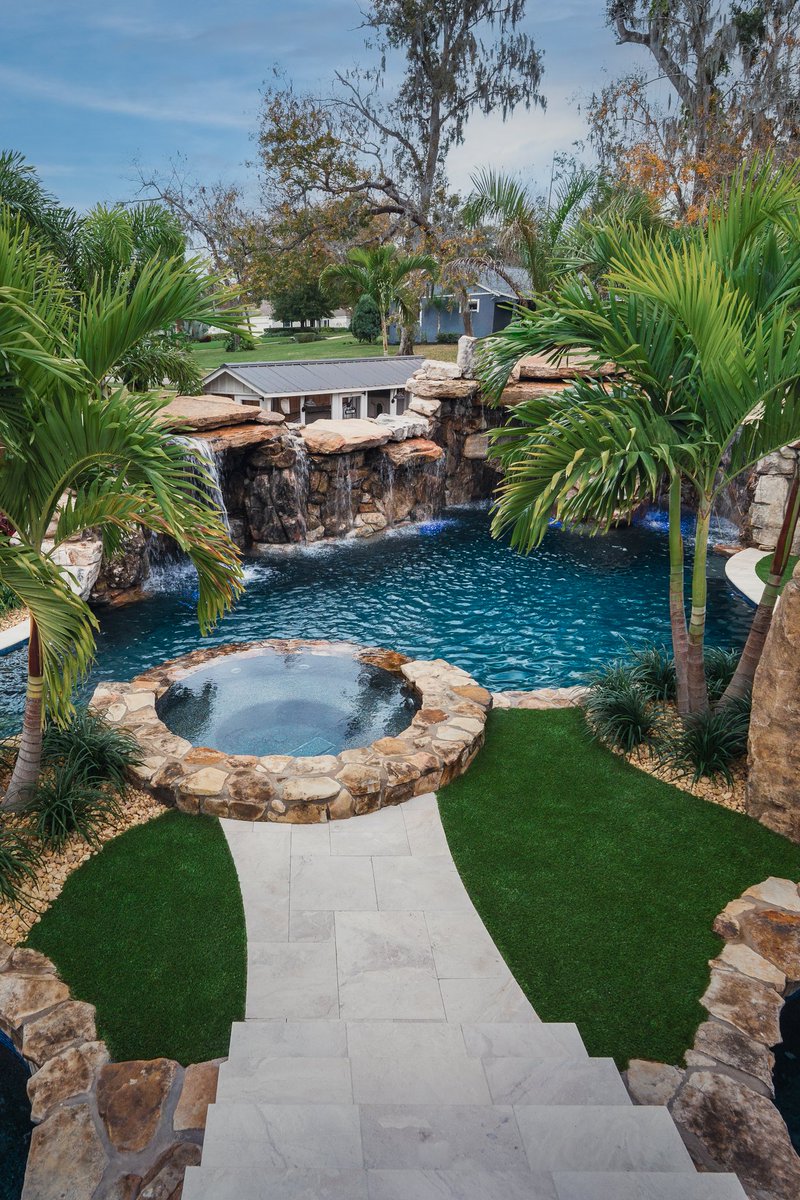 lucaslagoons's tweet image. Signature Series Insane Pool featuring a massive natural rock grotto with a dramatic rain curtain, a bridge leading to an island spa, and lush tropical landscaping that feels like a five-star resort. #insanepools #lucaslagoons #backyard