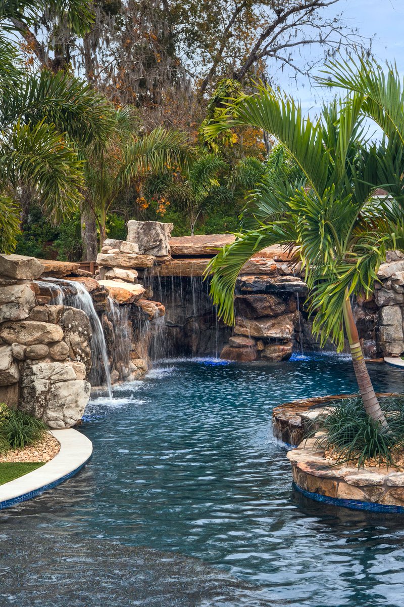 lucaslagoons's tweet image. Signature Series Insane Pool featuring a massive natural rock grotto with a dramatic rain curtain, a bridge leading to an island spa, and lush tropical landscaping that feels like a five-star resort. #insanepools #lucaslagoons #backyard