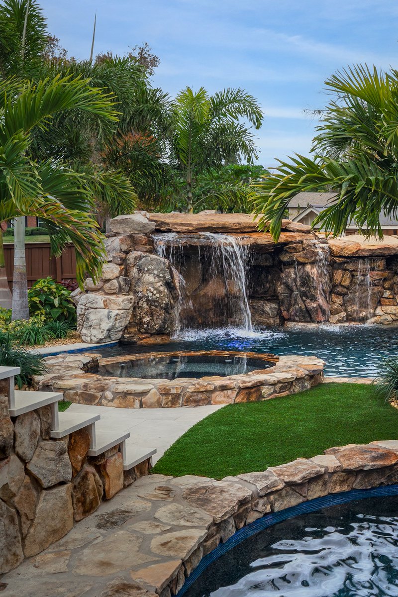 lucaslagoons's tweet image. Signature Series Insane Pool featuring a massive natural rock grotto with a dramatic rain curtain, a bridge leading to an island spa, and lush tropical landscaping that feels like a five-star resort. #insanepools #lucaslagoons #backyard
