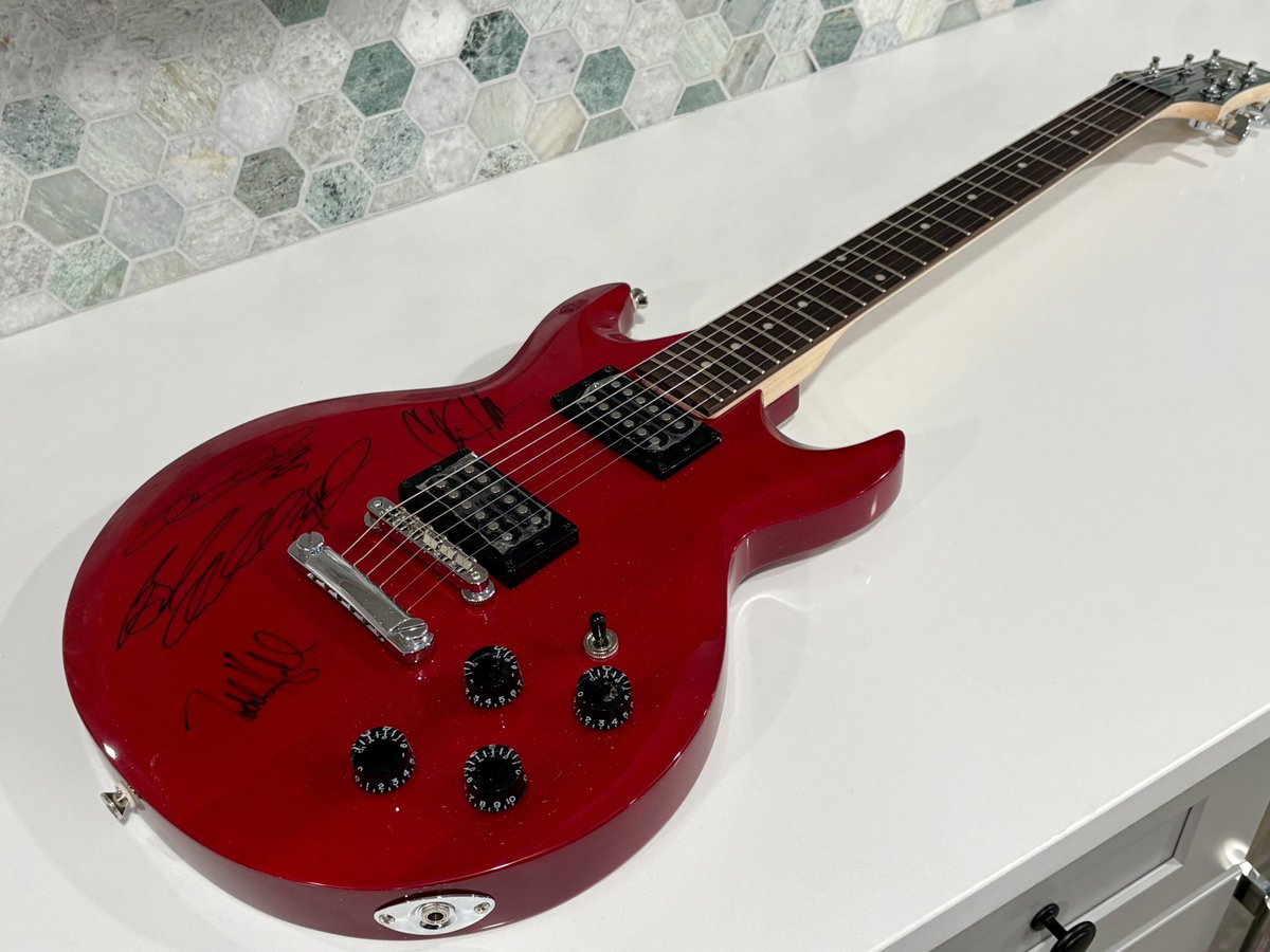 A signed <a href="/3doorsdown/">3 Doors Down</a> guitar. Great band. RIP Brad Arnold.