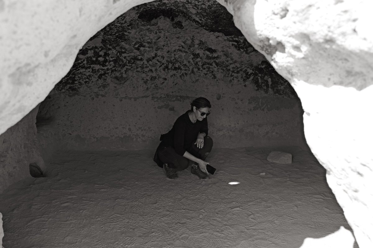 Roebot's tweet photo. 📍 Tsankawi, Bandelier National Monument, New Mexico 7/5 🥑  Standing on the same mesa where Ancestral Puebloans carved homes into volcanic tuff 1000+ years ago, you can see Los Alamos on the next ridge over. The place where one civilization built something sacred is within line of sight of where another civilization built something that could end everything.

Tsankawi is part of Bandelier National Monument, but feels nothing like it—no paved trails. No guardrails. You walk in the literal footsteps of the Ancestral Puebloans—petroglyphs on the cliff faces, carved cavates in the rock, and a trail worn so deep into the mesa top by centuries of human feet that you’re walking through a groove in solid stone.

The San Ildefonso Pueblo still considers this land sacred. Their ancestors lived here, farmed here, read the seasons in the canyon walls. The continuity is unbroken—this isn’t a ruin. It’s a living cultural landscape.

Then in the 1940s, the US government took the mesa next door and built Los Alamos National Laboratory. The Manhattan Project. The place where we split the atom and built the weapon that redefined what humans are capable of—for better and worse.

Two mesas. One where people built a civilization in harmony with the landscape over centuries, more than 1000 years. One where people unlocked the power to unmake landscapes in seconds.

I don’t have a lesson here. But walking the Tsankawi trail and feeling the weight of centuries of feet that carved footpaths while the lab sits quietly on the horizon is haunting.
