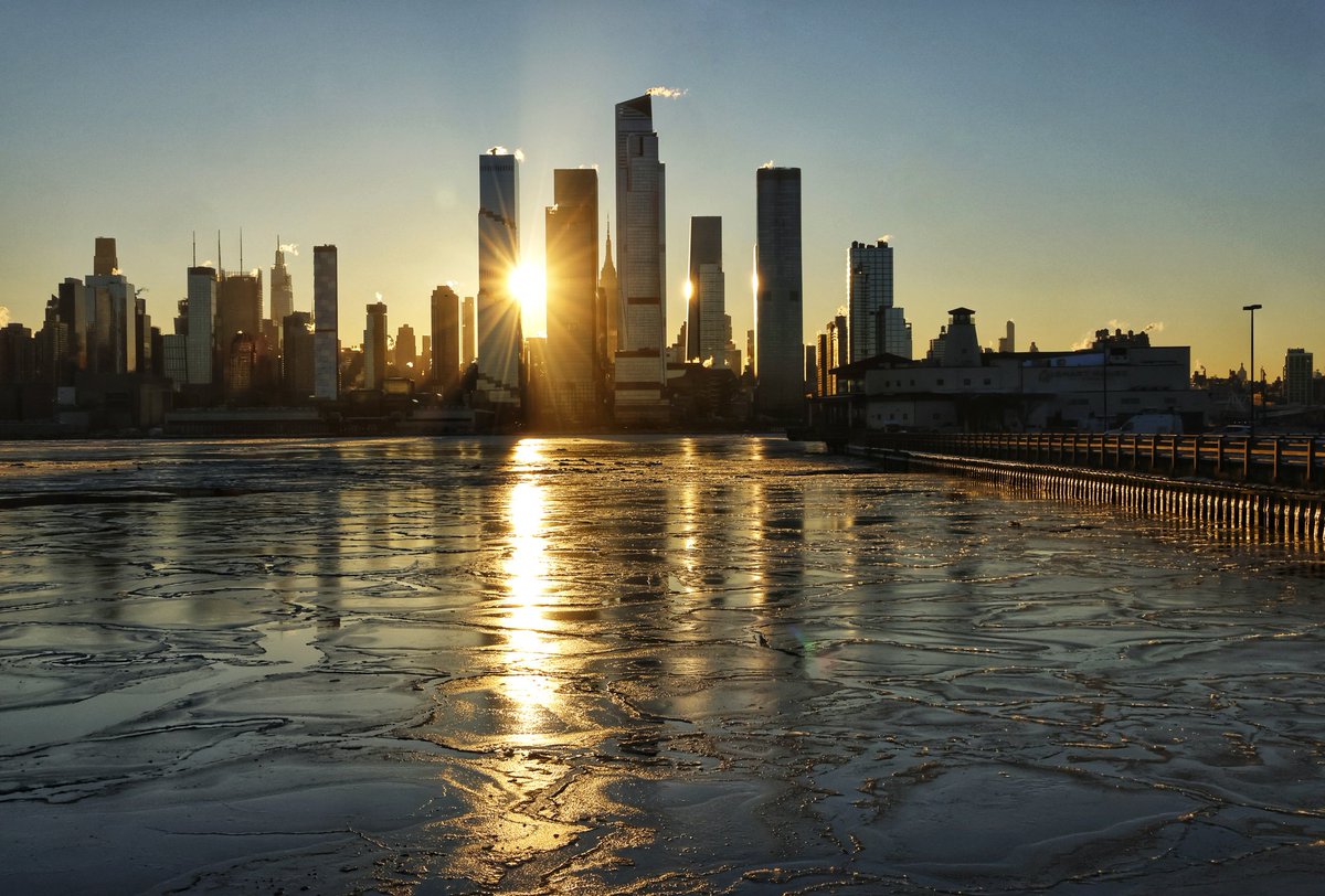 The sun rises behind the Empire State Building and towers of Hudson Yards in as ice floats in the Hudson River on another frigid start to the day in New York City #newyork #newyorkcity #nyc <a href="/EmpireStateBldg/">Empire State Building</a> #sunrise