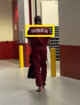 I think Patriots wide receiver Mack Hollins was actually letting us know what the Patriot's fnal score would be in the Super Bowl yesterday.. 

He's walking in handcuffs and leg irons representing the score they are locked into putting up by wearing a jumpsuit saying RANGE 13..🤦‍♂️