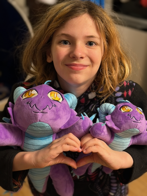 2026 is going big! Julie went a little off script and worked with Melissa McCommon (previous artist) to design a limited edition Mochi Plush! TWO SIZES! On sale this year! $29.99 for large (100 limit!), $19.99 for small (300 limit!). #toys #portconmaine #conventionmerch