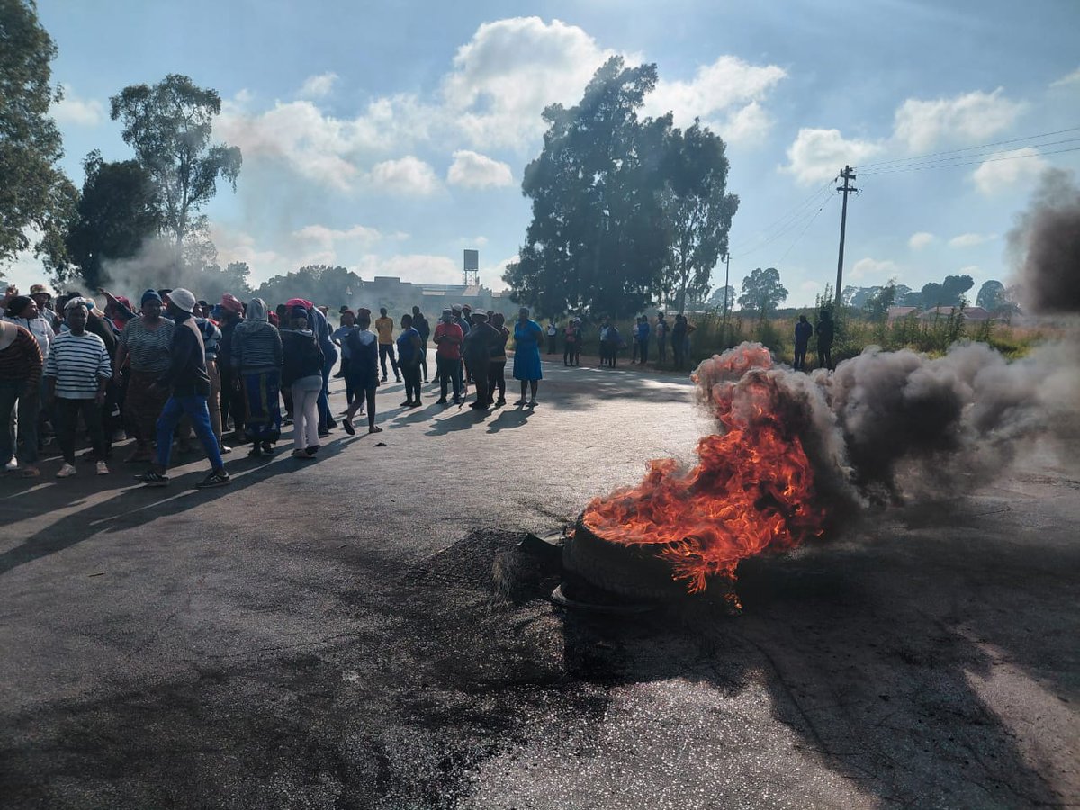 Parents protesting on the road blocking the street