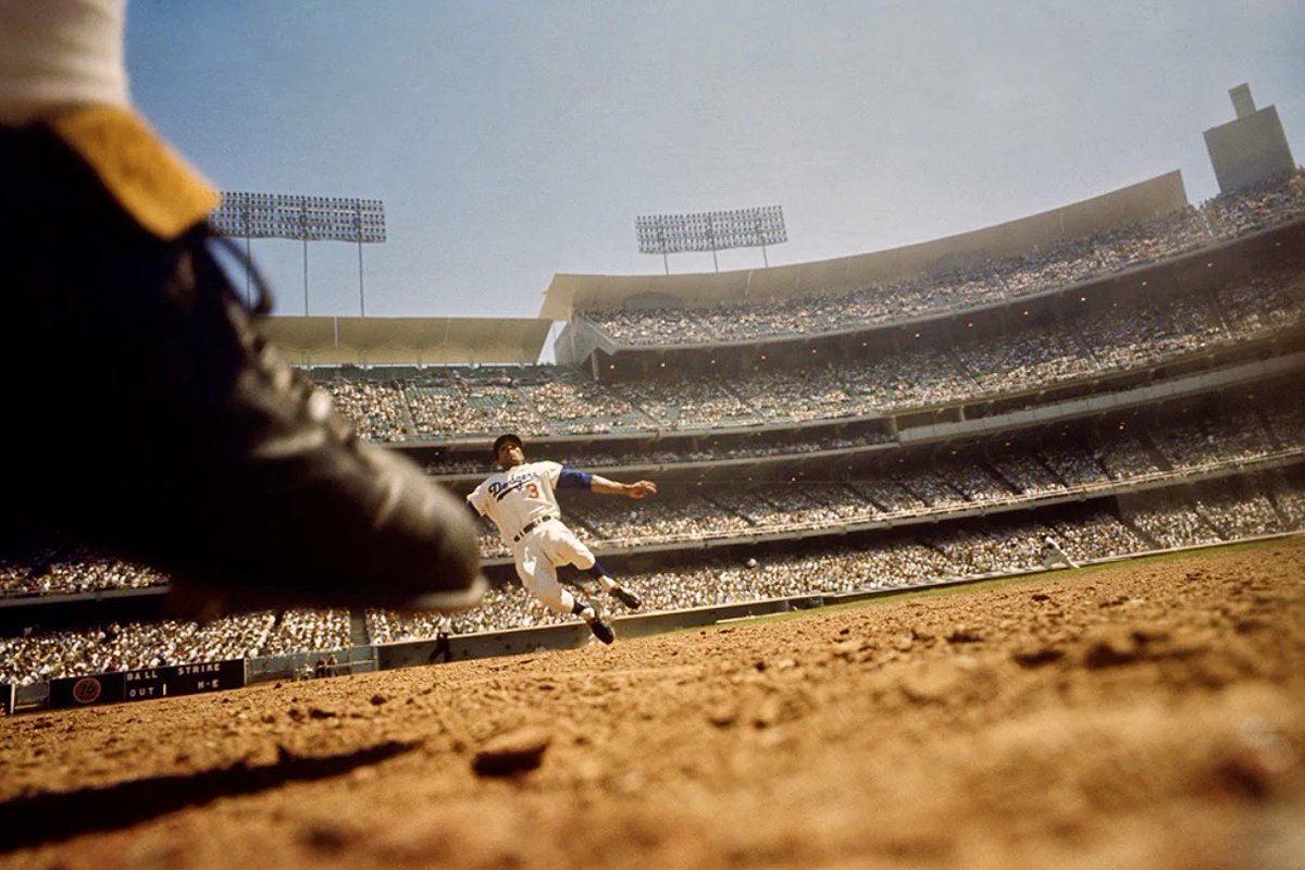 Legendary photographer Neil Leifer placed a camera in the second base bag at Dodger Stadium on 4/25/65. Willie Davis of LA slides into the base. The foot is believed to belong to Philadelphia 2nd baseman Tony Taylor