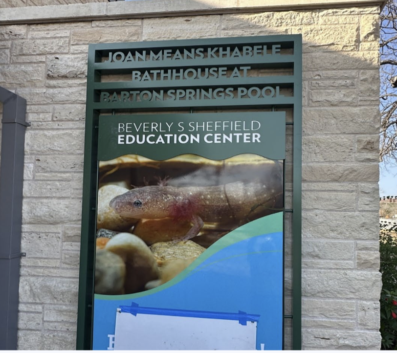 New sign for Joan Means Khabele Bathhouse at Barton Springs Pool. Lifeguard Scott Cobb nominated her and built community support to get the resolution passed by Austin City Council and paid the $365 nomination fee. Now, we have a beautiful newly renovated bathhouse named for her.