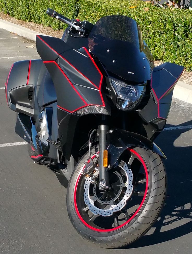 "Wouldn't be much of a biker without it~ " 

With a click of a small button held within a pocket on his jacket.  

A sleek black machine sprung to life behind him.  

"I call her Kurotora. Or The Black Tiger."