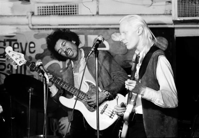 Jimi Hendrix and Johnny Winter sharing the stage at The Scene club in New York City, this rare moment captures Hendrix holding down the low end on bass while Winter shreds on guitar, 1968.  Photo by Bill Nitopi.