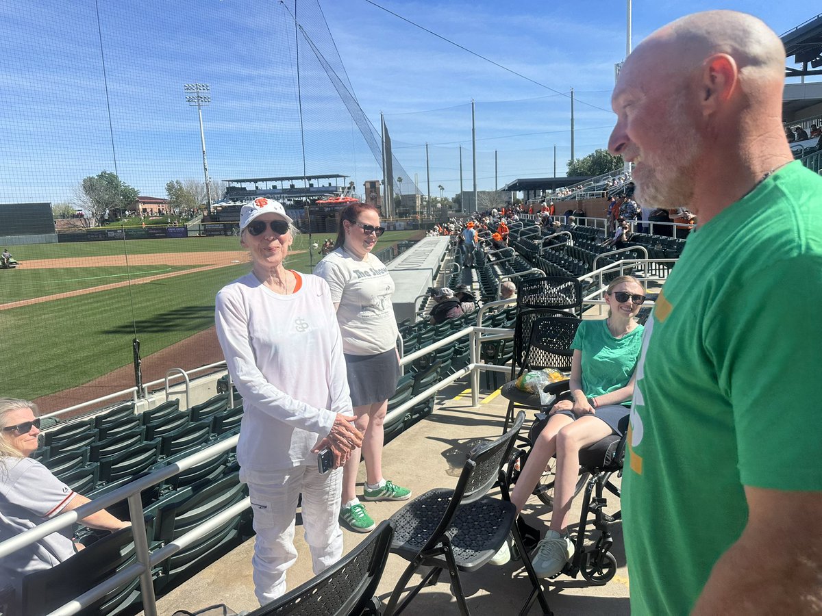 JanieMcCAP's tweet photo. A’s manager Mark Kotsay is wearing an “End ALS” T-shirt all game today instead of his jersey to support friend @SlangsOnSports, here with her family before reporting to Miami for World Baseball Classic. https://t.co/gKhFp2bUoU