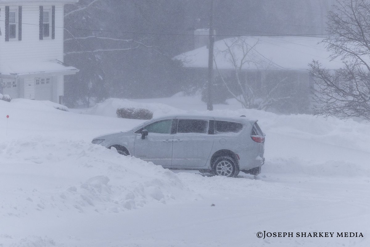 PhotoShark55's tweet photo. Waltham, MA - Blizzard conditions continue across Waltham as a powerful winter storm moves through eastern Massachusetts, bringing heavy snow and strong winds to the area. While main roadways have been cleared enough for limited travel, many side streets and residential roads remain snow covered and difficult to navigate. Blowing snow and drifting have reduced visibility at times and created slick, uneven road conditions.

Based on conditions observed throughout the city, Waltham has seen roughly a foot to a foot and a half of snow, with deeper accumulations and drifts in less traveled areas. As shown in the photos, vehicles have become disabled on untreated streets, and traction remains an issue in neighborhoods where plows are still working their way through.

Plow crews and emergency services continue to respond across the city, focusing on keeping main routes open while gradually clearing secondary roads. Drivers are urged to use caution, avoid unnecessary travel, and be aware that conditions can change quickly depending on snowfall rates and wind. Residents are encouraged to remain alert and give plow operators room to work as cleanup efforts continue.