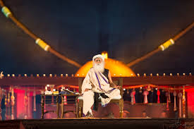 bigfundu's tweet photo. 4. “The sacred becomes sensation; depth is replaced by stimulation”

Article’s point: Heavy bass, flashing lights, mass chanting - spiritual culture is sliding toward dopamine.

My counter to this point: Shiva, the Adi Yogi, himself is known for both his tandava and his stillness. So, obviously, Silence and Celebration are both legitimate spiritual technologies.

Actually, the core of Isha's Mahashivratri celebrations is not in the music and festivities, but in the meditations Sadhguru initiates lakhs of people into on that night. 

It was very evident when the sound system failed in this Mahashivratri 2026 celebration, and Sadhguru simply came on to the ramp, encouraging the crowd to chant 'Shiva Shiva Shivaya' for almost 30 minutes non-stop.

Why mass chanting on that night? A chant, as proved by modern science, is a mechanism to bring focus back into life rhythms. This is our ancient tech that most youngsters have just lost touch with. 

Large group chanting simply amplifies what solo practice does more quietly. Have you seen the recent Gen-Z bhajan clubbing trends? It is just a variant of this tech. 

By the way, nobody is coerced into chanting, attending, or following. Participation in the events and in chanting is voluntary - unlike historical state religions.

As I said earlier, the celebrations are an entry point for someone to get attracted to the path. But the highest spiritual program offered by Isha is called 'Silence' for a reason.

5/🧵