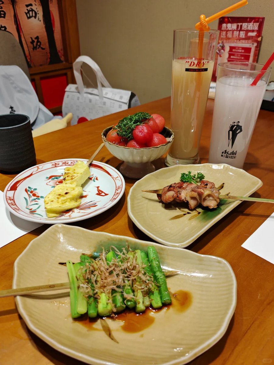 今晚赤鬼丁又给我整蛊了！这“送福利脸”西瓜圆得像个害羞小胖子顶着绿毛，烤菠萝贼甜还wink，鸡肉串和葱段一本正经cos高级菜～配杯SUPER DRY直接笑到社死，谁懂这种快乐啊哈哈哈！（42字）