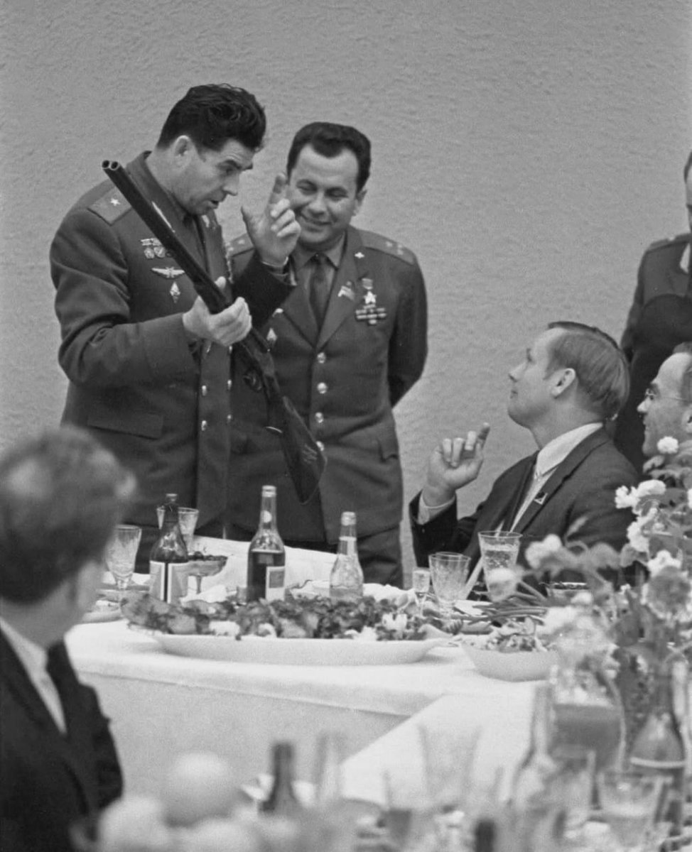 October 1970. Soviet cosmonauts Georgy Beregovoy and Pavel Popovich present a commemorative hunting rifle to American astronaut Neil Armstrong, the first man to walk on the moon.