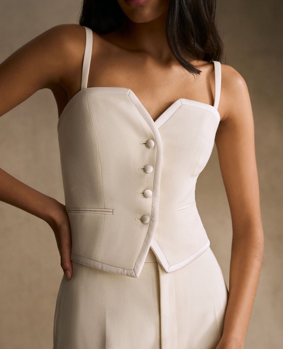 The tuxedo cami waistcoat reimagines classic tailoring with a modern edge. Cut in fine British wool with silk satin framing, it’s as refined under suiting as it is worn solo.

Discover more at Knatchbull, 32 Savile Row.