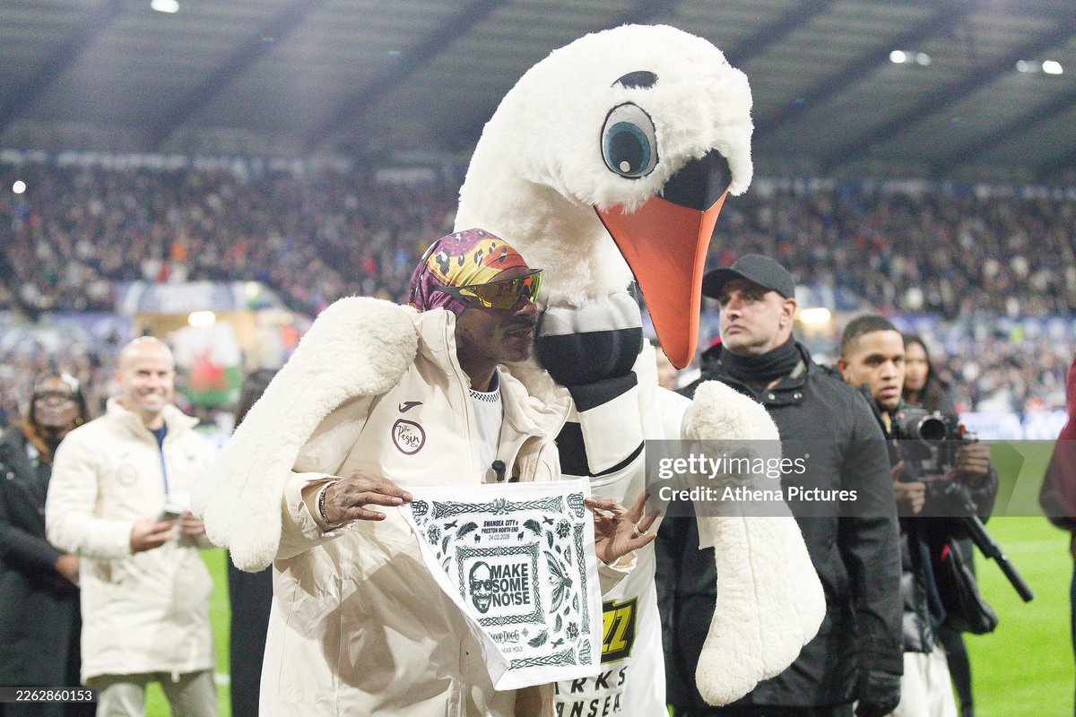shitbritishpics's tweet photo. Swansea City AFC club co-owner Snoop Dogg with club mascot Cyril the Swan, walks around the pitch prior to the Sky Bet Championship match between Swansea City and Preston North End at the Swansea .com Stadium (2026) https://t.co/Khxq46J5Br