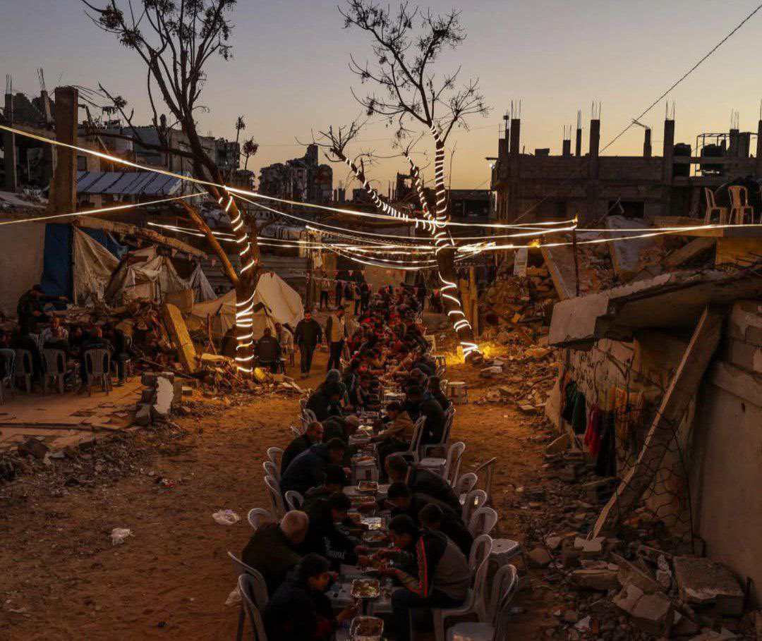 Palestinians in Gaza are breaking their Ramadan fast together, sharing iftar meals in the rubble of homes destroyed by Israeli forces. Photo by Shehab News.