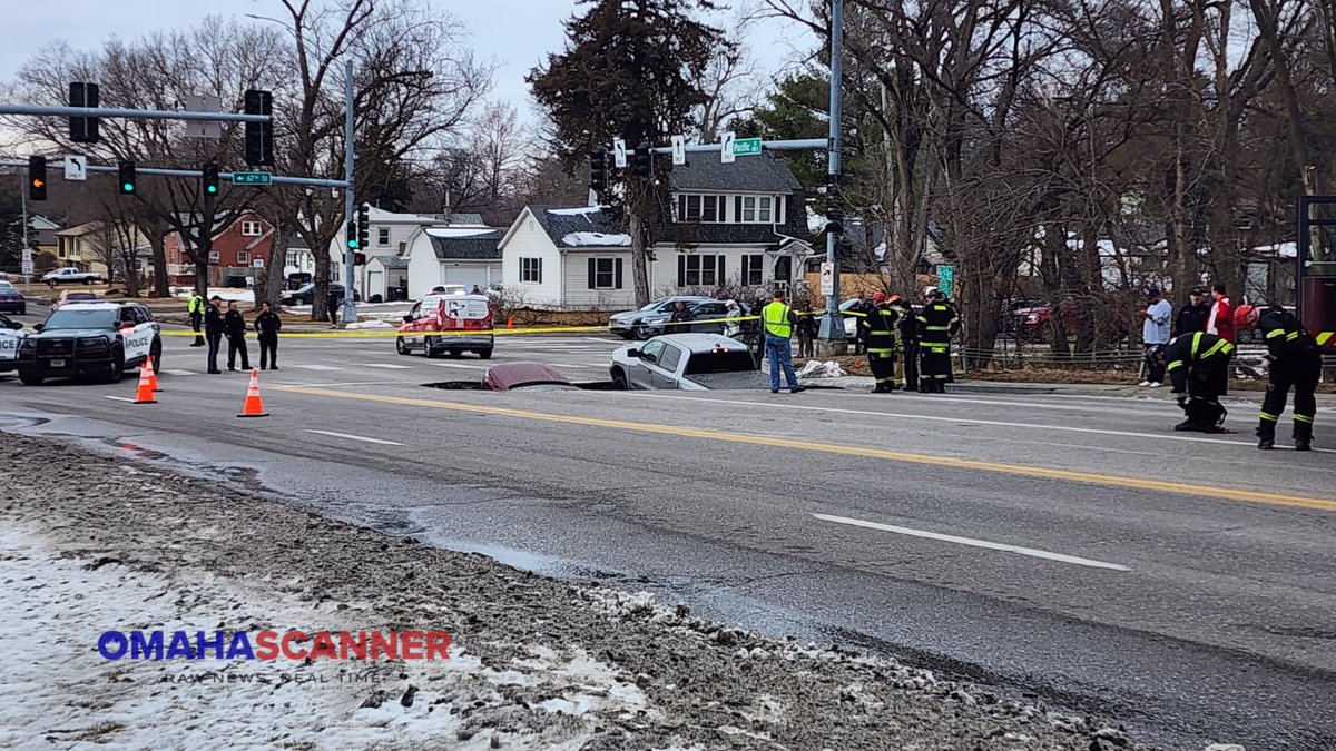 omaha_scanner's tweet photo. At 3:32 p.m., Omaha Fire and Omaha Police were called to a large sinkhole with two cars inside near 67th and Pacific Street. All occupants were able to get out safely. Avoid the area due to the road missing. https://t.co/dRN0epEnzf