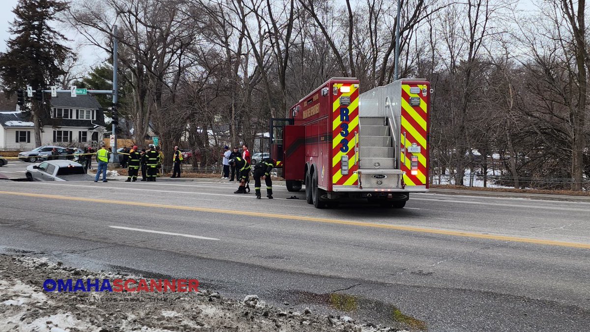 omaha_scanner's tweet photo. At 3:32 p.m., Omaha Fire and Omaha Police were called to a large sinkhole with two cars inside near 67th and Pacific Street. All occupants were able to get out safely. Avoid the area due to the road missing. https://t.co/dRN0epEnzf