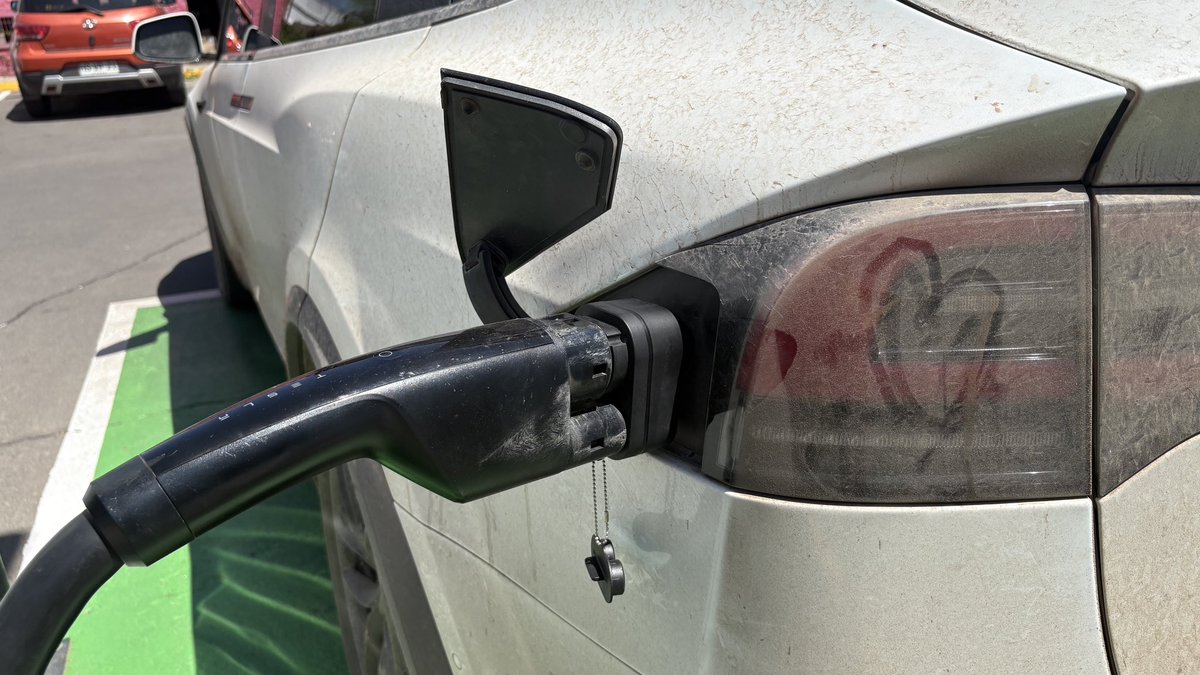 Everydaysandro's tweet photo. Tesla has 2 Supercharger Locations Open in South America. I decided to see if I could charge my North American Model X, Beluga, with NACS in Santiago Chile. This is what I learned…

To get here, I drove 34,300 Kilometers (21,437 miles) across 13 countries through some of the most beautiful, remote, and dangerous areas in the world. 

I have a special NACS to CCS2 adapter, which I have used all over Latin America, but what  I was worried about, was that the car UI maps are North American, meaning the chargers do NOT register in the UI..

First attempt - Fail. 

Then Jimmy said, keep trying by pressing the button. Keep going…

Second attempt - Click, Click. I saw the Tesla logo blinking GREEN! 

We were charging, at 180kW, the fastest charge  I have had in all the Americas. WILD! 

Remember, some places I have averaging 3amps…1kW if I was lucky! 

Then, once the charge was done, from 38% to 80% SoC, taking about 25 minutes, I got the error that my credit card could not be used to pay for the charging, meaning I could potentially be locked out.. I reentered by credit card, and magic, I paid for the charging! 

$10,900 Pesos - $12.67 
$300 Pesos kWh - $0.35

WHOAAAA. I was speechless…a kid, running around the car, so happy! High on life! 

I then made Jimmy, my friend traveling with me for the next few weeks, make it official, by placing the Chilean Flag underneath Belugas hood and signing his name and date to register the moment! 

A few hours later we drove to the Tesla store in Santiago, and explained about my expedition! 

The love I received and charger received will be shared in another post! 

@Tesla @Tesla_LatAm @ohjimme