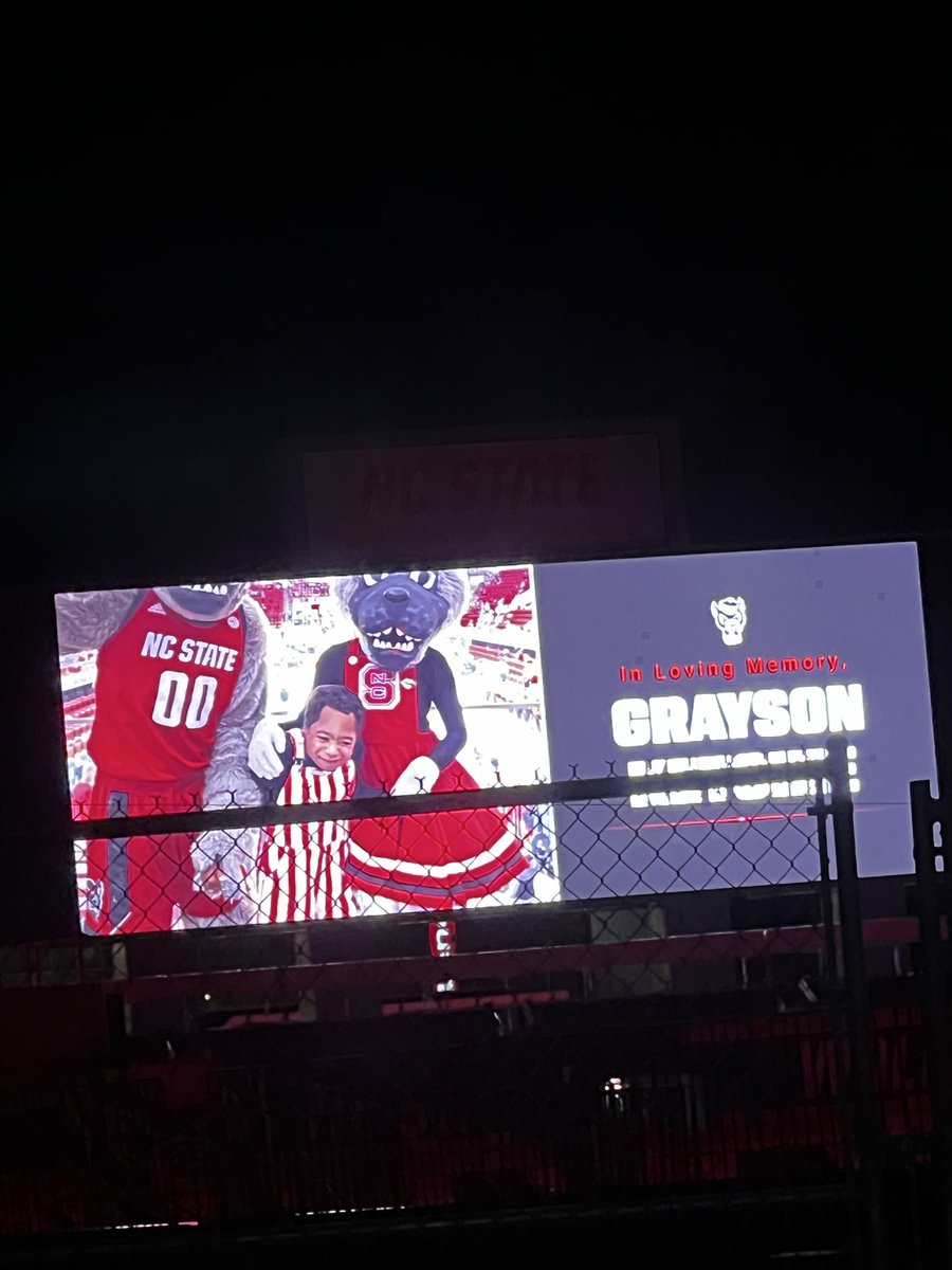 WufPackMama's tweet photo. Heaven is shining a little brighter tonight with Grayson in it. Carter-Finley is lit red in memorial of Grayson tonight. Rest easy sweet angel! #wolfpack #ripgrayson #ncsu https://t.co/3muqLf8YzD