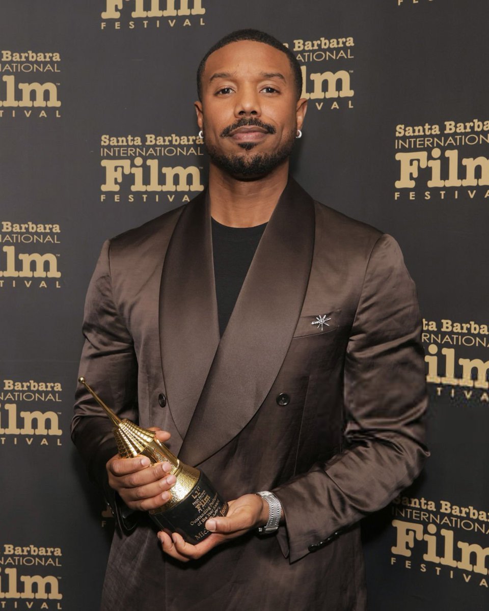michael b. jordan with his outstanding performer of the year award at the #SBIFF. ✨