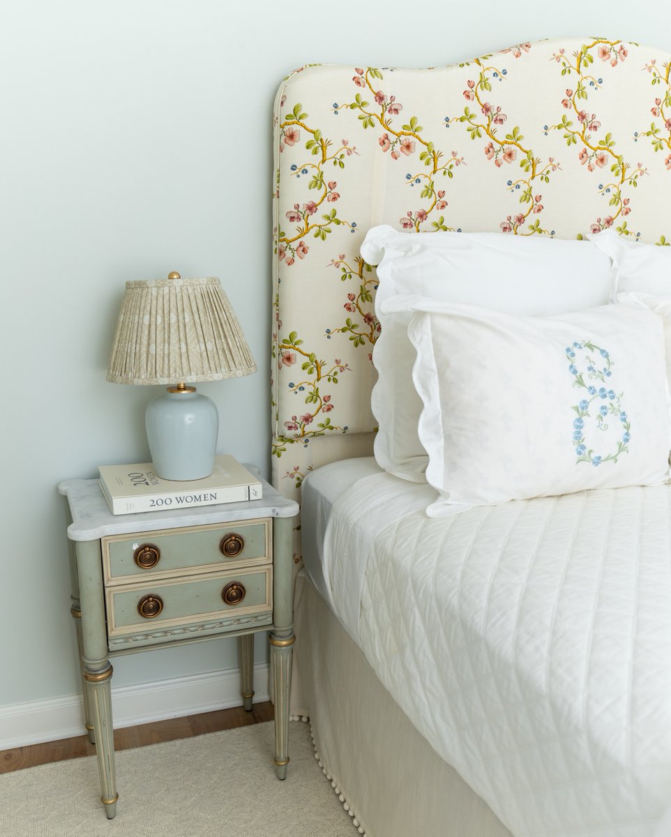 We spy Etienne. A favorite in bedrooms going for a delicate, feminine feel, this accent table pairs beautifully with <a href="/elizabeth/">Elizabeth Weil</a>.w.cook’s scalloped bedding and floral headboard. bit.ly/3LYbxkr