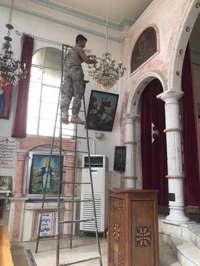 Turkish soldier repairing a Church in Syria.
