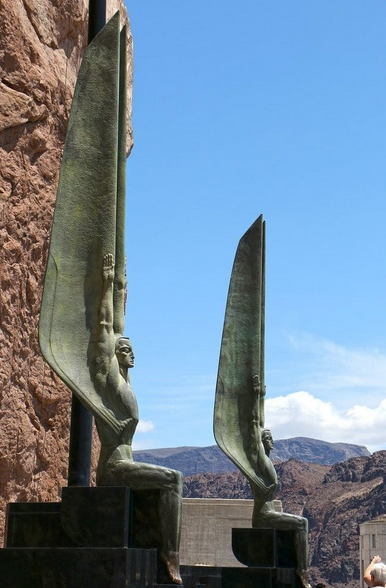 Sculpted guardian angels standing at the entrance of Hoover Dam.