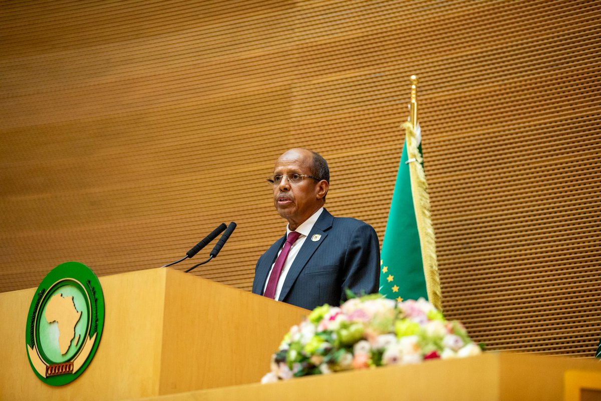 AU Commission Chairperson Mahmoud Ali Youssouf speaking at the podium during summit sessions emphasizing peace and security