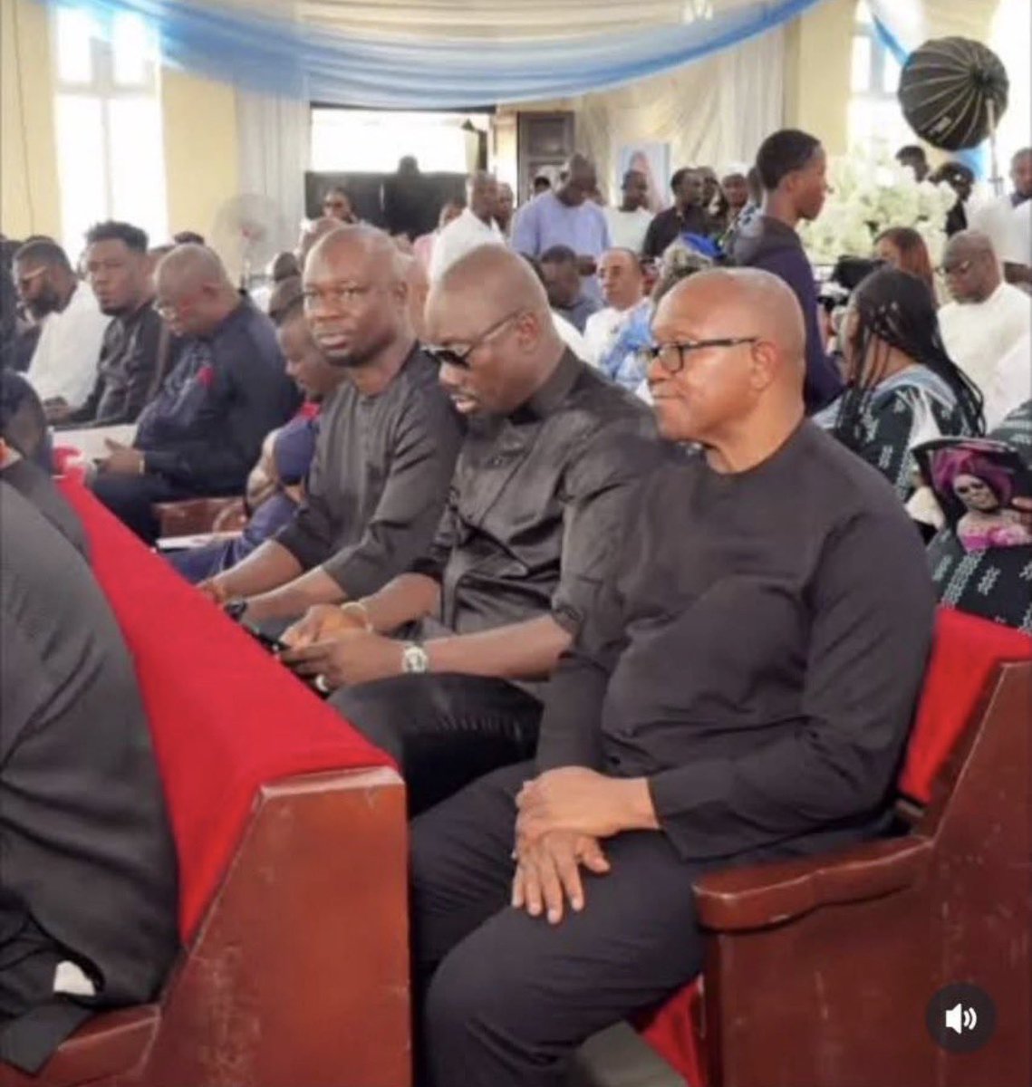 Obi Iscariot sitting beside Peter Obi.