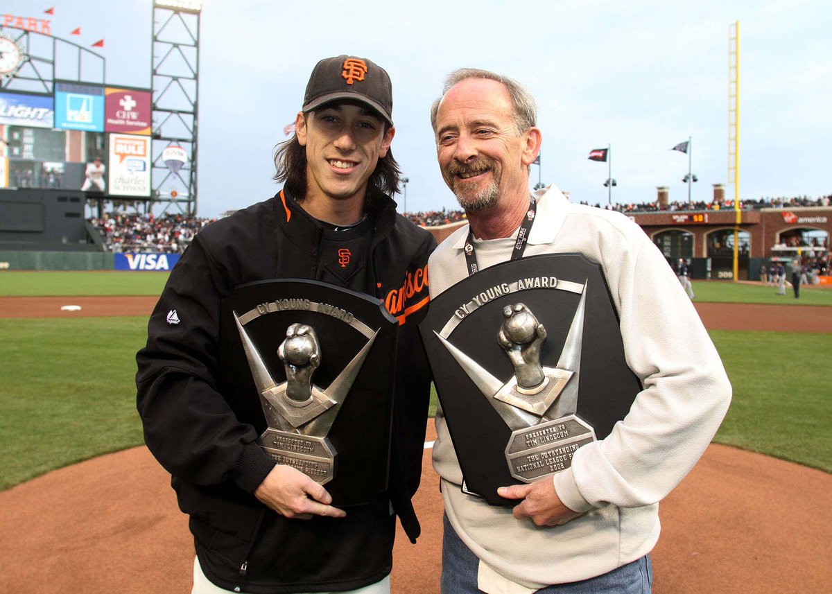 Tim Lincecum and his dad with his two Cy Young Awards.