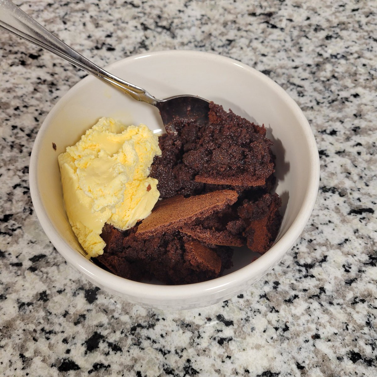 My first time making a brownie pudding. The top tastes like the edges of a brownie, and the inside is the consistency of cake... but tastes slightly undercooked like a lava cake. Nice texture &amp; delicious.😋