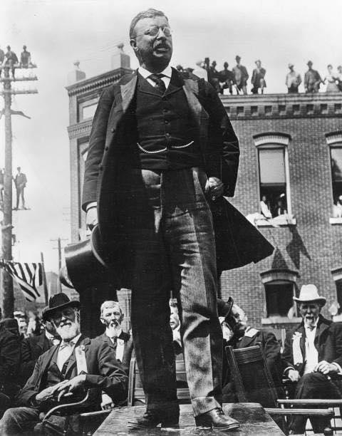 Theodore Roosevelt campaigning in 1912. Look closely, men were on rooftops and even telephone poles just to hear him speak.