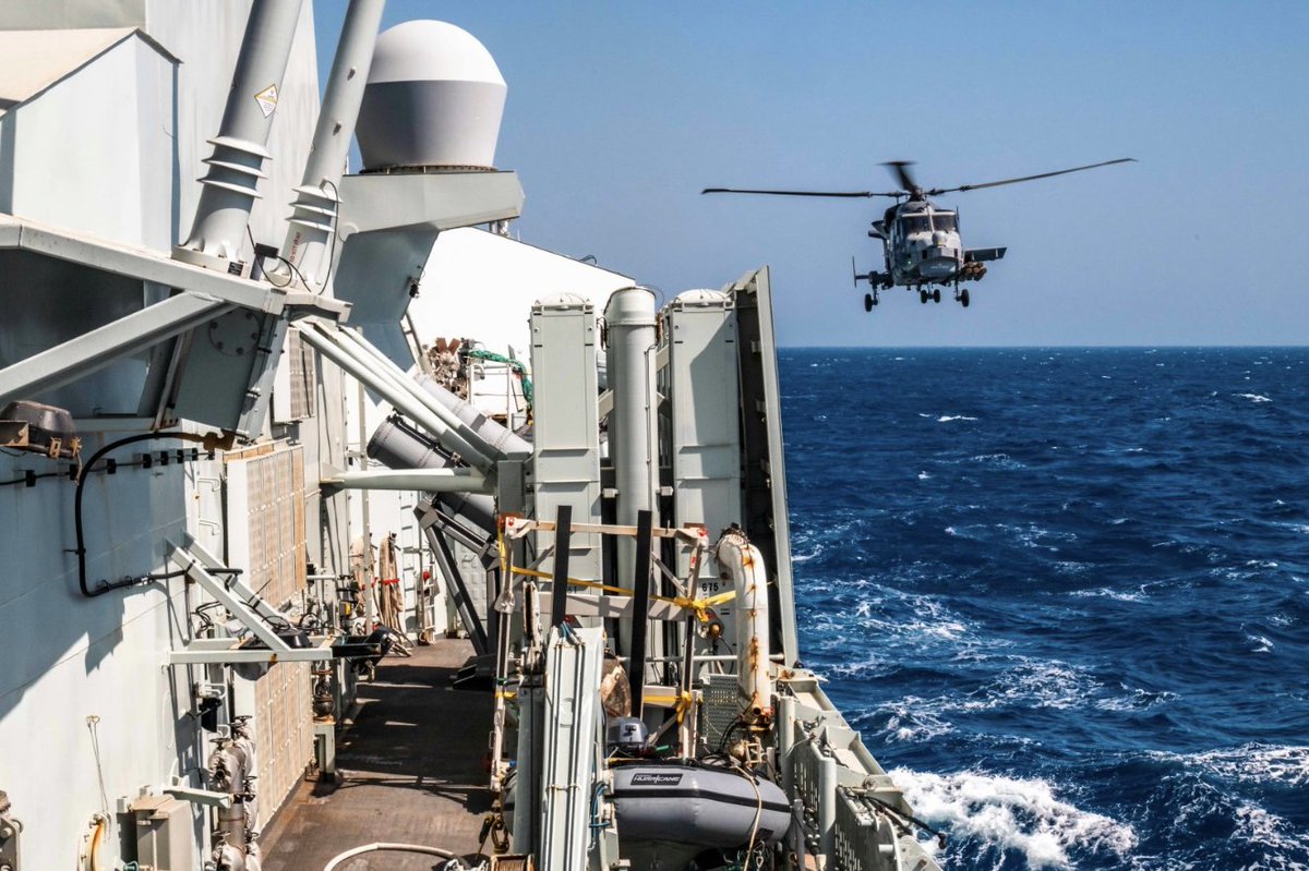 edc_magazine's tweet photo. Wildcat helicopter, Black Pearl, flies next to #HMCSVilledeQuebec after receiving fuel, while sailing as a part of the UK-led Carrier Strike Group, during #OpHORIZON, in the Red Sea.
Photo by: Corporal Brendan Gamache, Formation Imaging Services https://t.co/bpIii6ulG1