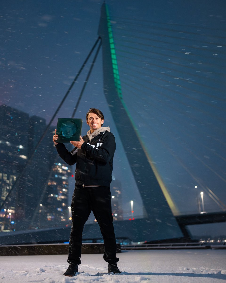 Iconic. 2026 champion Alex de Minaur, with his #abnamroopen trophy in hand and the snow falling from above, meets the unmistakable Erasmusbrug. ❄️🏆📸
