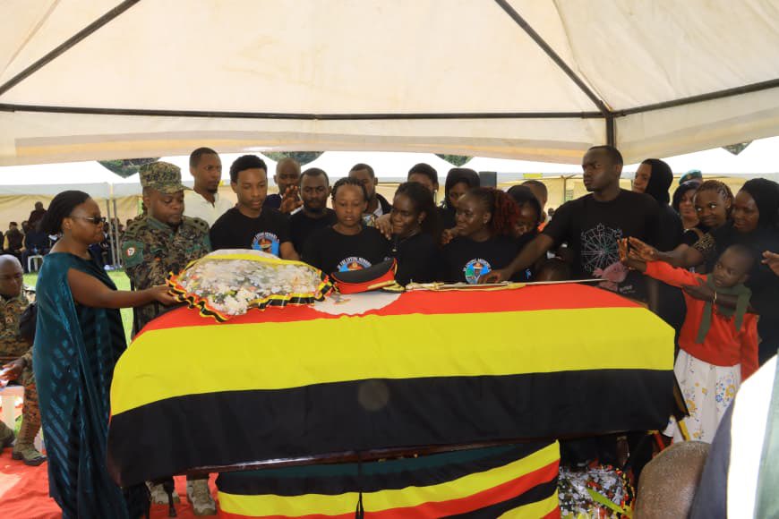 kamukamafredie's tweet photo. The former Commander of the Armoured Division of the Uganda Peoples’ Defence Forces (UPDF) Major General Deus Karachi Sande, has been laid to rest at his ancestral home in Kacuro Village, Kigata Parish, Kyanamira Sub-county, Ndorwa East County, Kabale District.
The fallen General, who passed away on February 11, 2026, due to respiratory complications, was honoured with a 13-gun salute in a ceremony defined by tributes to his “legacy of sacrifice, professionalism, and loyalty.”
Representing the government, the Minister of State for Trade, Hon Gen Wilson Mbasu Mbadi, described the late Maj Gen Sande as a results-oriented officer whose dedication was central to the nation’s current stability and urged serving soldiers to reflect on the legacy they will leave behind and emulate the late’s contributions to peace and national stability.
“To soldiers, you should learn from Gen Sande’s contributions so that you can be like him or even better,” Gen Mbadi said.
The Minister challenged serving officers to be mindful of the legacies they leave behind, noting that Sande’s ability to integrate seamlessly into any community made him an approachable and highly effective leader.
Speaking on behalf of the Chief of Defence Forces (CDF), the Joint Staff Political Commissariat, Maj Gen Henry Masiko, described Maj Gen Sande as an officer of unique character who balanced duty with personal life and was always accessible and dependable.
”Gen Sande hardly ever switched off his phone; no matter the hour, he was available,” Maj Gen Masiko remarked.
He characterised the late General as a distinguished officer whose resilience and integrity earned him the admiration of both superiors and subordinates alike.
The widow, Mrs. Annet Sande, remembered her husband as a pillar of the family who extended his care far beyond his three biological children.
”General Sande and I had three children together, but we have many other children under our care,” she shared, describing him as a deeply compassionate man.
She expressed gratitude to President Yoweri Kaguta Museveni and the UPDF leadership for the trust placed in her husband through various command and staff appointments. “I strongly believe that he did not disappoint you.”
The requiem mass, led by Rev. Fr. Davis Keinamura, was attended by government Ministers, UPDF generals, senior and junior officers, Resident District Commissioners, Members of Parliament, religious leaders, friends, and family.