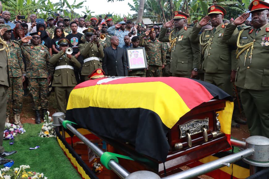kamukamafredie's tweet photo. The former Commander of the Armoured Division of the Uganda Peoples’ Defence Forces (UPDF) Major General Deus Karachi Sande, has been laid to rest at his ancestral home in Kacuro Village, Kigata Parish, Kyanamira Sub-county, Ndorwa East County, Kabale District.
The fallen General, who passed away on February 11, 2026, due to respiratory complications, was honoured with a 13-gun salute in a ceremony defined by tributes to his “legacy of sacrifice, professionalism, and loyalty.”
Representing the government, the Minister of State for Trade, Hon Gen Wilson Mbasu Mbadi, described the late Maj Gen Sande as a results-oriented officer whose dedication was central to the nation’s current stability and urged serving soldiers to reflect on the legacy they will leave behind and emulate the late’s contributions to peace and national stability.
“To soldiers, you should learn from Gen Sande’s contributions so that you can be like him or even better,” Gen Mbadi said.
The Minister challenged serving officers to be mindful of the legacies they leave behind, noting that Sande’s ability to integrate seamlessly into any community made him an approachable and highly effective leader.
Speaking on behalf of the Chief of Defence Forces (CDF), the Joint Staff Political Commissariat, Maj Gen Henry Masiko, described Maj Gen Sande as an officer of unique character who balanced duty with personal life and was always accessible and dependable.
”Gen Sande hardly ever switched off his phone; no matter the hour, he was available,” Maj Gen Masiko remarked.
He characterised the late General as a distinguished officer whose resilience and integrity earned him the admiration of both superiors and subordinates alike.
The widow, Mrs. Annet Sande, remembered her husband as a pillar of the family who extended his care far beyond his three biological children.
”General Sande and I had three children together, but we have many other children under our care,” she shared, describing him as a deeply compassionate man.
She expressed gratitude to President Yoweri Kaguta Museveni and the UPDF leadership for the trust placed in her husband through various command and staff appointments. “I strongly believe that he did not disappoint you.”
The requiem mass, led by Rev. Fr. Davis Keinamura, was attended by government Ministers, UPDF generals, senior and junior officers, Resident District Commissioners, Members of Parliament, religious leaders, friends, and family.