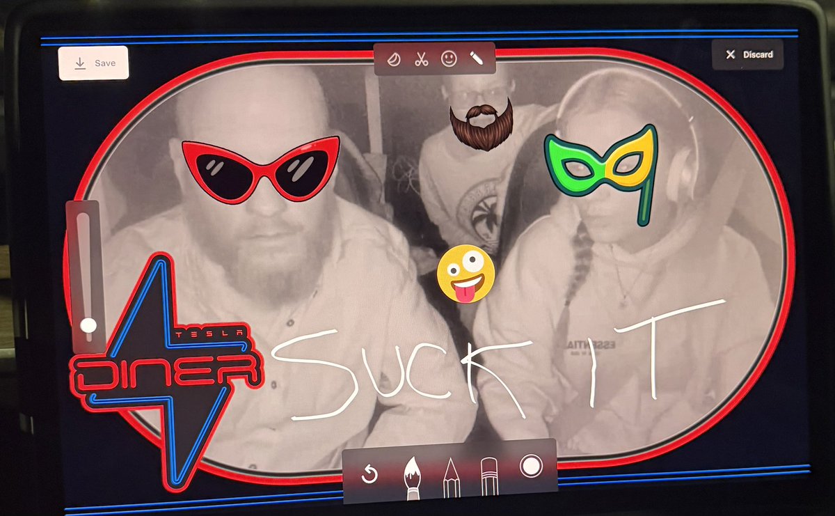ThomasHuffman79's tweet photo. Thanks @Tesla for turning charging time into a doodle-fest extravaganza on the way to the Chicago Auto Show! Who knew scribbling ‘Suck IT’ on the screen with neon vibes could make waiting so epic? @elonmusk, your cars are the ultimate boredom busters. 🚗⚡ #TeslaFun #ChargingAdventures #ChicagoAutoShow