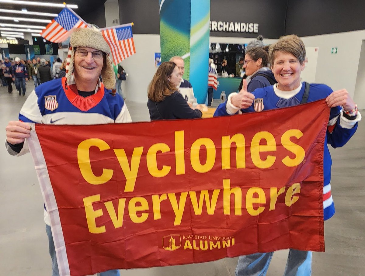 isualum's tweet photo. Iowa State alum Sam Strotman (‘86) is cheering on Team USA 🇺🇸 at the Olympics in Italy and ran into another Cyclone fan! @CycloneMBB senior Nate Heise’s sister plays for the women’s hockey team and his mom Amy was so excited to see a #CyclonesEverywhere flag! https://t.co/W1WoUMJw28