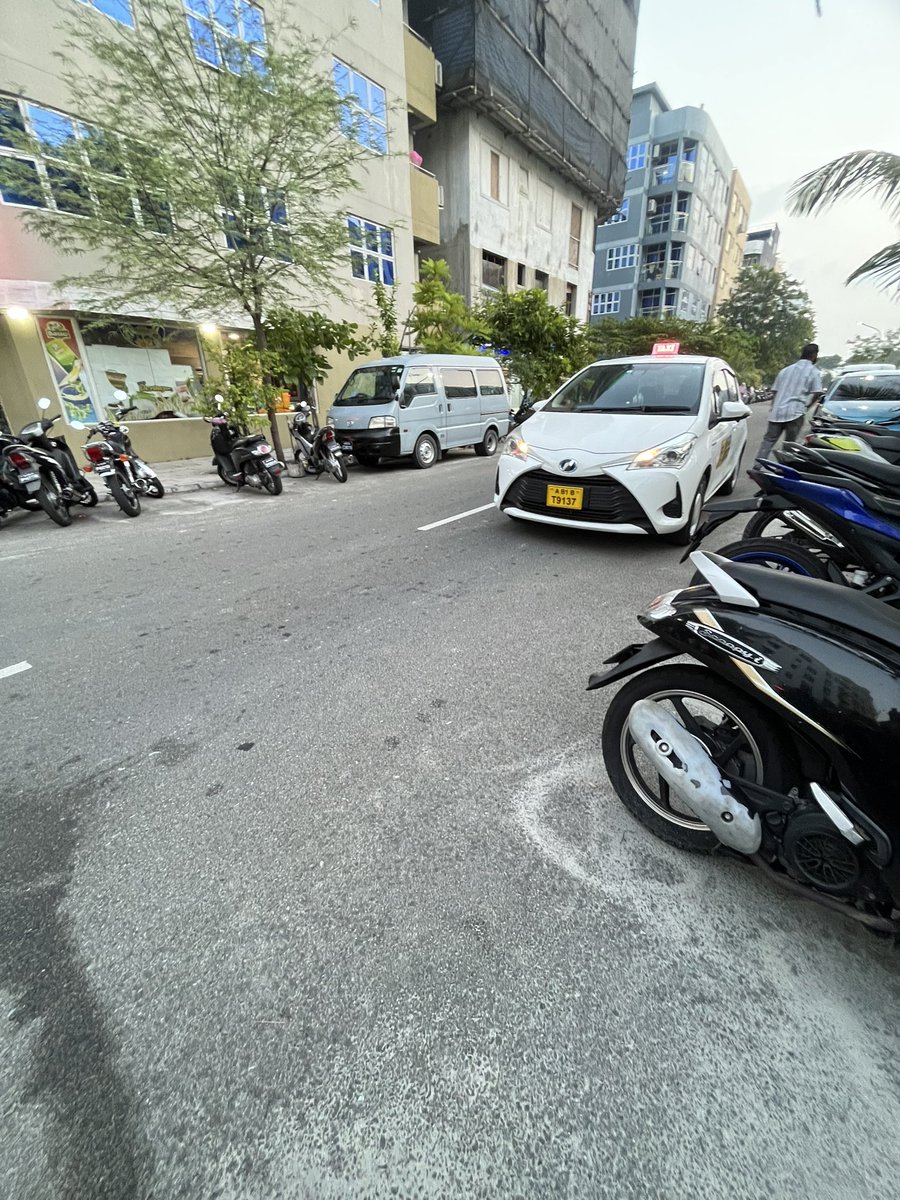The driver calmly enjoys a cigarette, parking the car, blocking one lane and does not bother to move a bit, as if it's his own property, even when others have to try and look for a chance to go forward. 
<a href="/PoliceMv/">Maldives Police</a> when you patrol why don't you check on these issues?