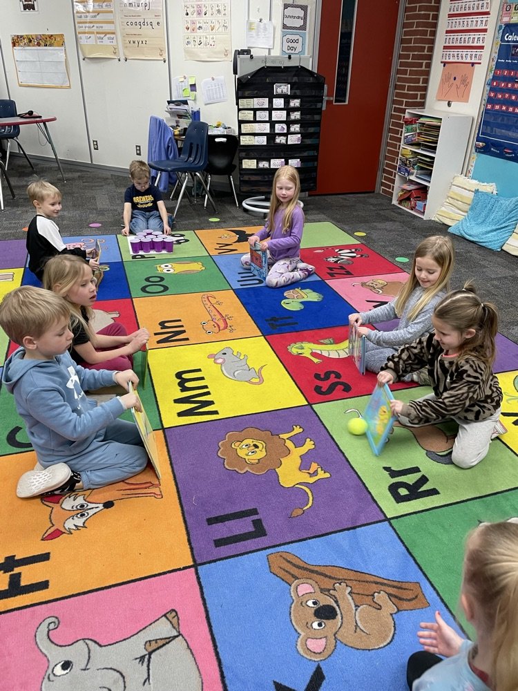 Kindergarten is on their force and motion unit. Here they're doing human bumper bowling.