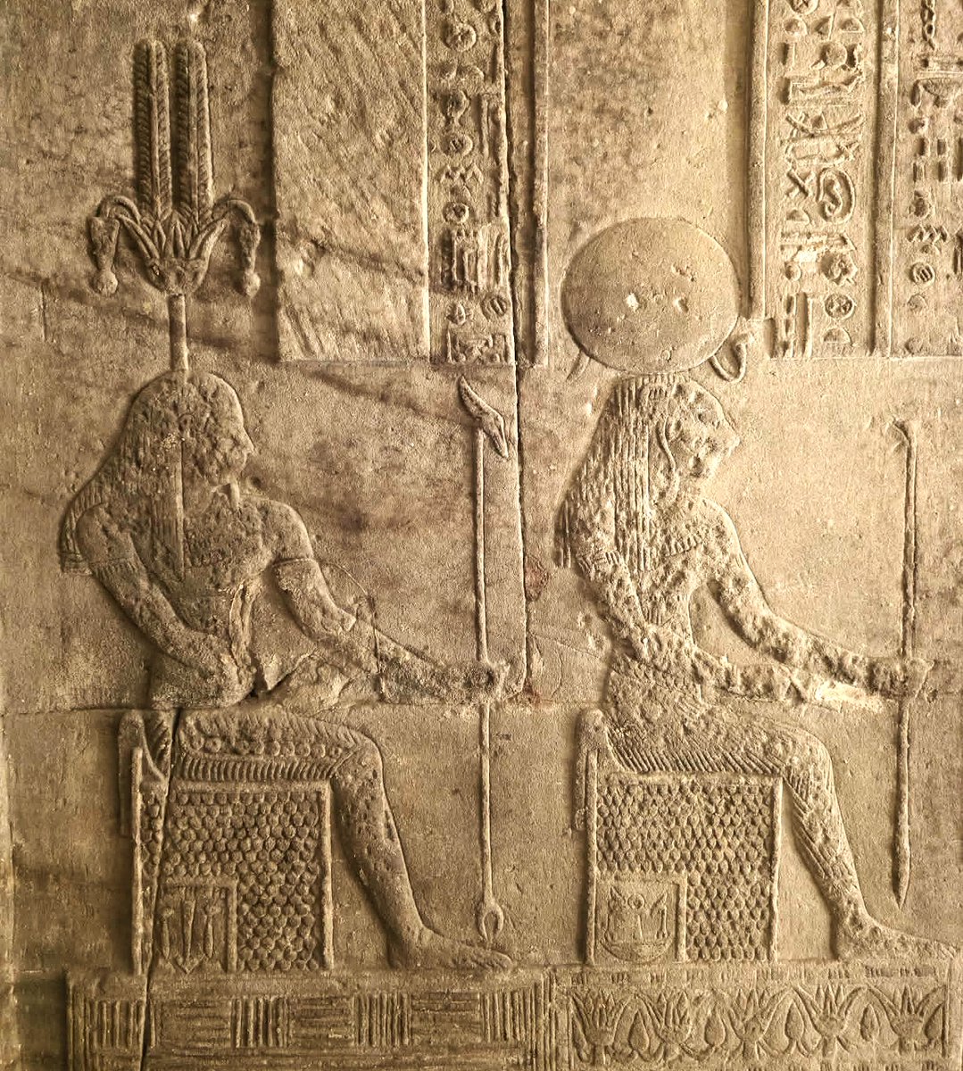 The Neter Nefertum, which translates as the "Harmony of Atum" or the "Harmony of the Atom" who is said to have been born from a blue lotus bud which emerged from the waters of Nun. His mother was Sekhmet, who is portrayed sitting in front of him holding the lotus staff.  Hakim