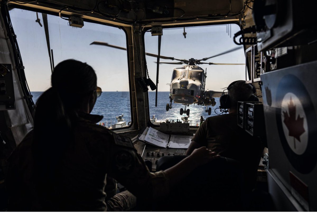 edc_magazine's tweet photo. Wildcat helicopter, Black Pearl, hovers over #HMCSVilledeQuebec’s flight deck as it prepares to land, while sailing as a part of the UK-led Carrier Strike Group, during #OpHORIZON, in the Red Sea.
Photo by: Corporal Brendan Gamache, Formation Imaging Services https://t.co/t6qgkRfMpo