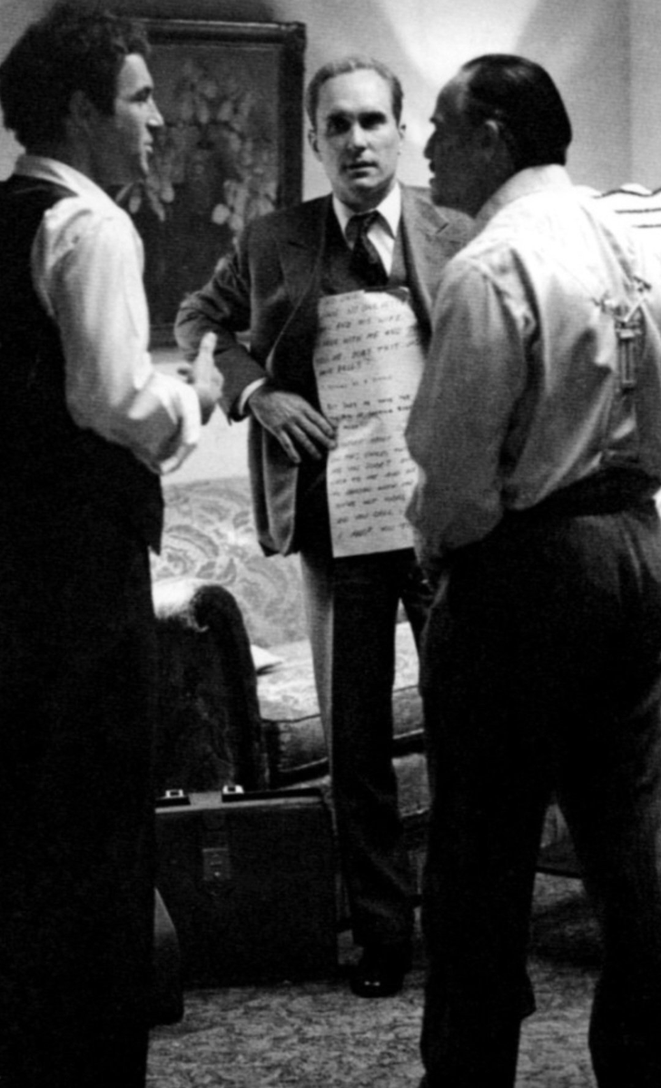 One of the most famous behind-the-scenes moments from The Godfather (1972), with Robert Duvall holding cue cards for Marlon Brando during a scene to help him remember his lines.