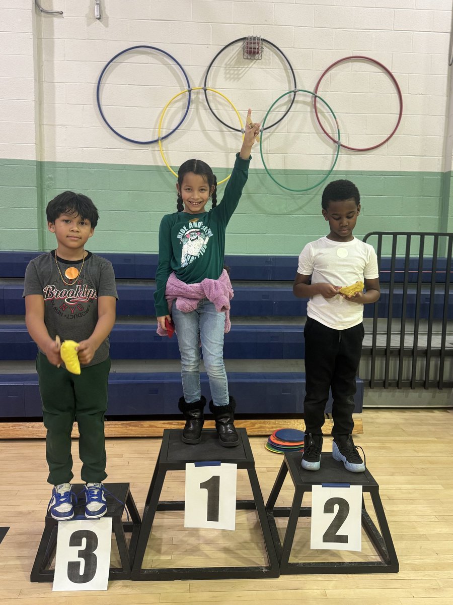 JohnAdamsElem's tweet photo. In PE, students have been learning about the Olympics and the sport of curling with daily head-to-head tournaments. Students win gold, silver, or bronze medals and get to stand on the podium with th Olympic rings displayed on the wall. 🥇🏅🥌 #curling #BeEager #PE4thewin @ACPSk12 https://t.co/wyHUcHTuEN