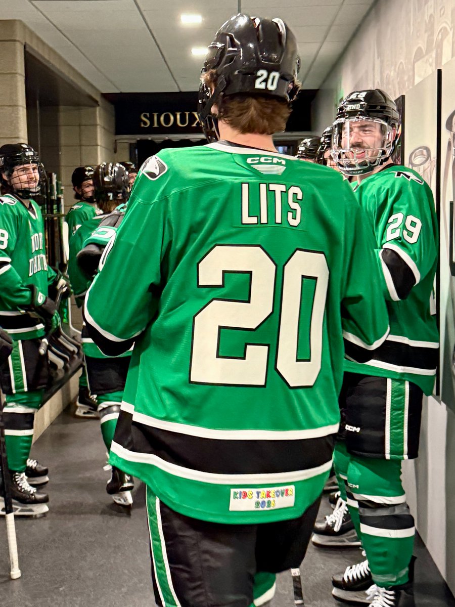 TheREA's tweet image. Only a few hours left in the Kids Takeover UND Hockey Jersey auction! Jerseys feature each player's childhood nickname, commemorative patch and were worn in warmups last Friday night. Proceeds benefit UND Hockey NIL.

Place your bids until 9 PM at: pd.undalumni.org/jersey