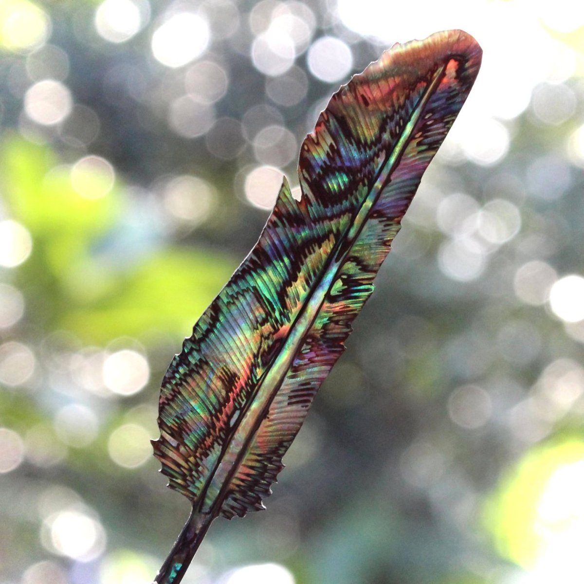 A feather carved from an abalone shell.