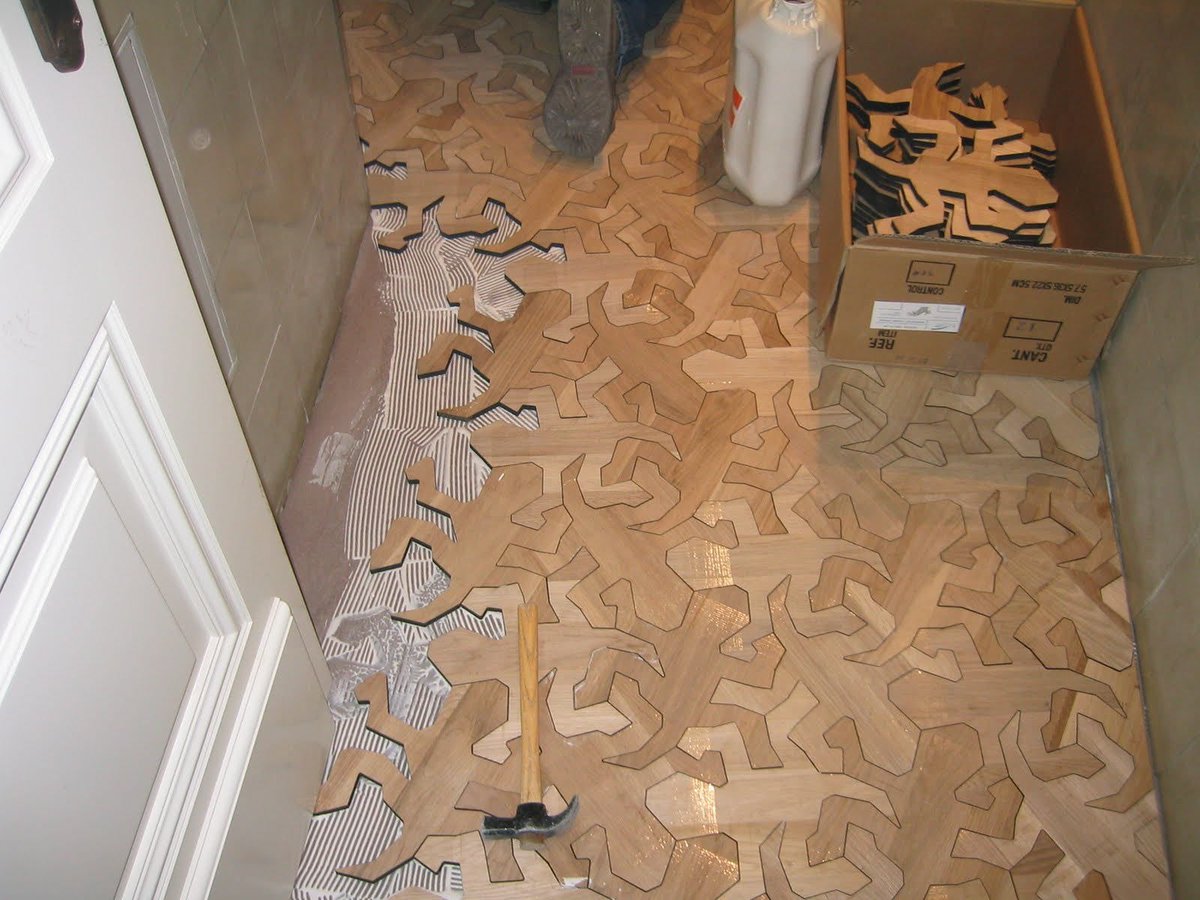 Today I learned that the Spanish company Arbore is taking inspiration from M.C. Escher's tessellated lizards for their floor designs. 😍